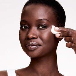 photo of woman applying double wear stay in place foundation that balances oil and hydration in skin