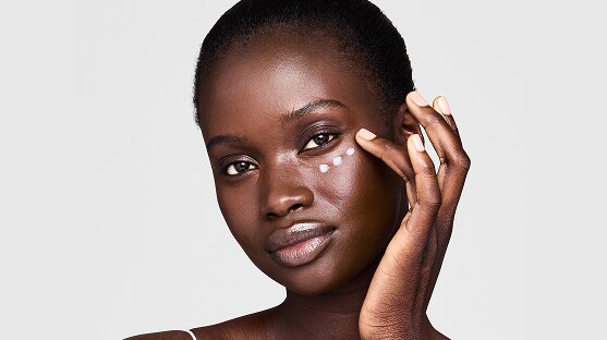 photo of woman applying eye cream to get rid of undereye wrinkles and lines