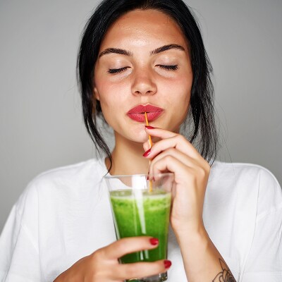 photo of woman drinking longevity smoothie